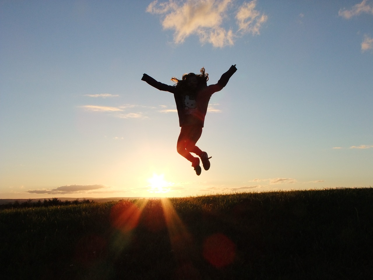 Jumping excitedly against a sunset